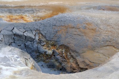 The Krafla mud pots hiss and steam.