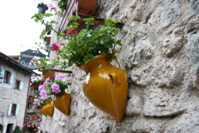 Hung flowers on a cobblestone wall