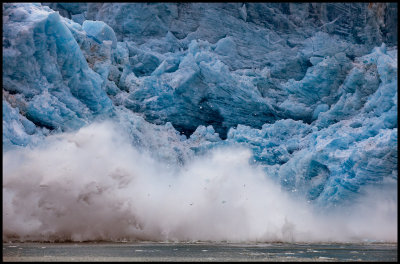 Glacier ice falling in to the ocean creating big waves