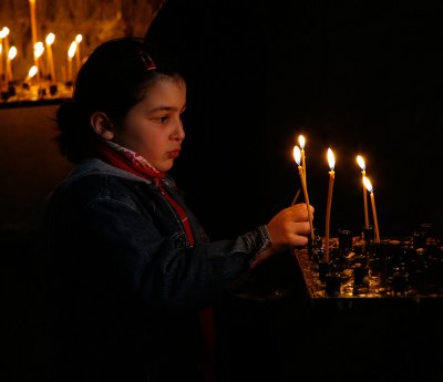 Child lighting candles in Dzvan