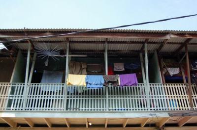 Drying clothes in of the wooden house's balcony