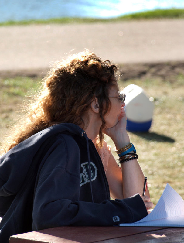 Pretty Lady Contemplating And Taking Notes...