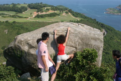 Anson watching Carol climbing the Rock at Tin Ha Shan