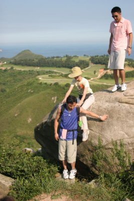 Jacky helping Lisa down the Rock at Tin Ha Shan