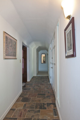Hallway from family room to the bedrooms. Main entry is on the middle right and living room middle left