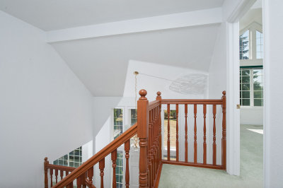 Upstairs hallway, stairs going down and master bedroom to the right