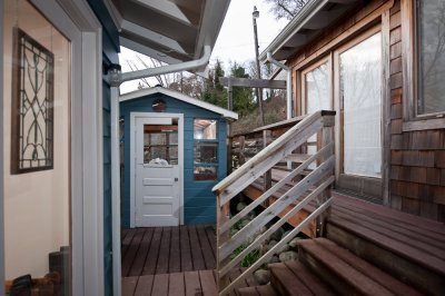 Main house on the left, greenhouse in the middle and studio on the right