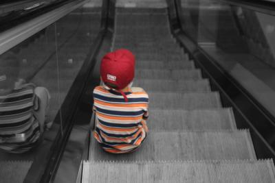 Taken of a young boy, riding the escalator at the Minneapolis Airport