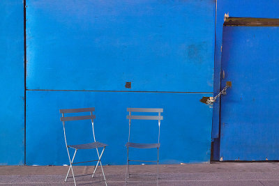 Two Chairs Against a Blue Wall