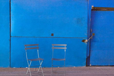Two Chairs Against a Blue Wall