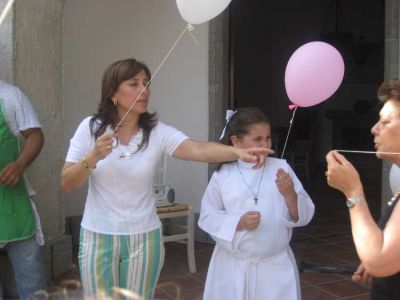 Flaminia in her communion gown with balloon.JPG