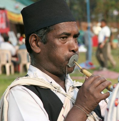 Blowing a Nepali instrument
