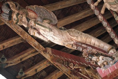 Wodden figure; there are so many under the roofs in Bhaktapur