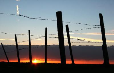Sunset behind the fence.