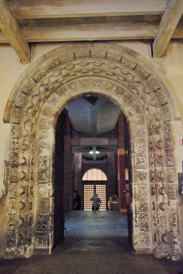 Norman doorway leading out to very brave C20th chapter house/reception centre