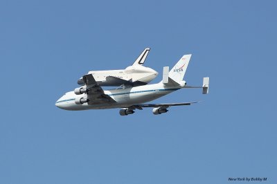 The Space Shuttle piggybacked atop a Boeing 747 