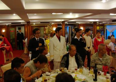The Captain and two ship's interpreters at the final dinner on the cruise ship.