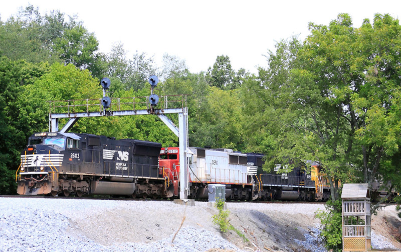 Southbound 143 passes the CP at Geneva, seen through the new hole created by the derailment of train 215 last month 