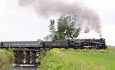 NKP 765 charges across a small creek near La Crosse on a cloudy Sunday Morning