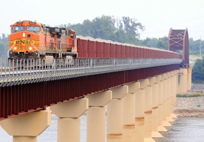 A BNSF ballast train, being handled by the Paducah & Louisville RR, crosses the nw bridge over KY lake 