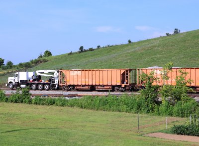 A NS BRANDT truck leads 4 loaded ballast cars South, near McKinney, headed for the 215 derailment site 