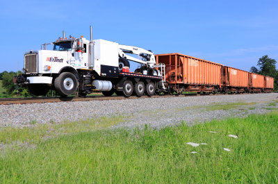 A NS BRANDT truck leads 4 loaded ballast cars South, near McKinney, headed for the 215 derailment site 