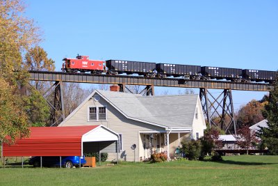 A N&W caboose trails a empty coal train across the bridge North of Troutville 
