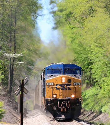 CSX 563 South tops over the big hill at Watkins, and will soon be stopping to cut off his pushers 