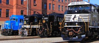 A mix of modern and vintage EMD power in front of the N&W office building 
