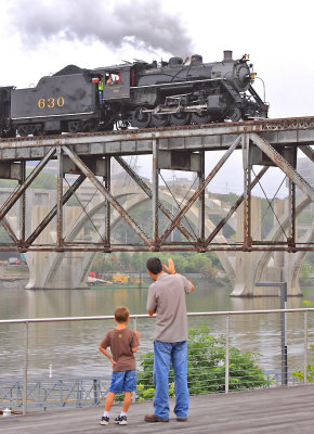 A father and son wave at the engineer on 630 as the train heads South to Alcoa 