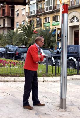 Man reading bus signpost