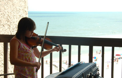 Every afternoon she practiced Christmas Music for the people in the pool below