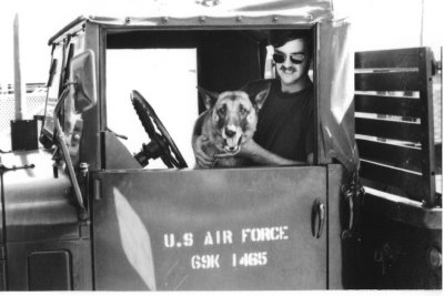 A1C Mark Smoot & Jake-0X14 posting truck.  Jake never got the hang of backing up. April 1971