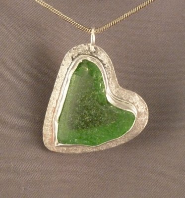 This pendant features a piece of beach-glass that has NOT been altered - this is the shape it was found. Sold.