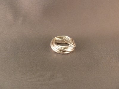 Nine intertwined sterling silver bands.