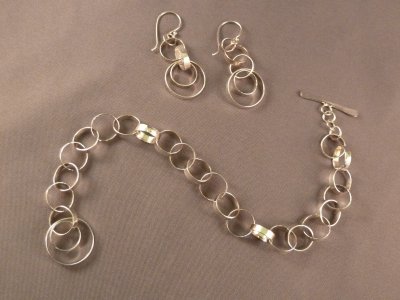 This chain bracelet jingles lightly when you move.  Fortunately, the earrings are quieter.