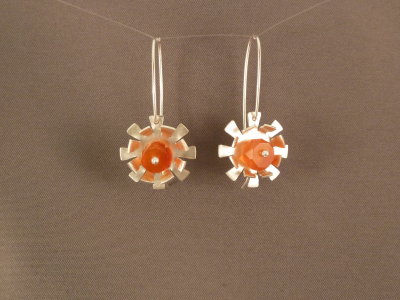 Funky flower earrings with a bright orange carnelian bead at the centre.