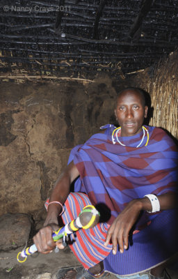 Masai Guide with Talking Stick Inside Masai House