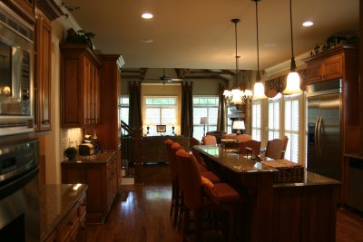 view of Kitchen & Family room & the stairs that lead upstairs. 