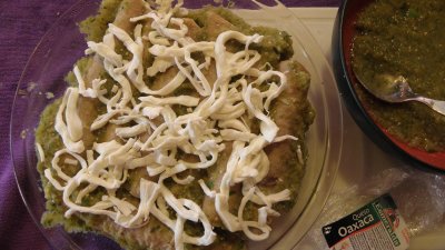Enchiladas covered with salsa verde y queso oacaco