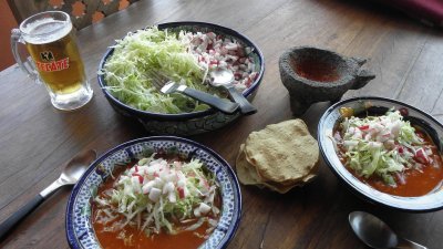 Ready to eat Pozole topped with with lettuce radish and a lime