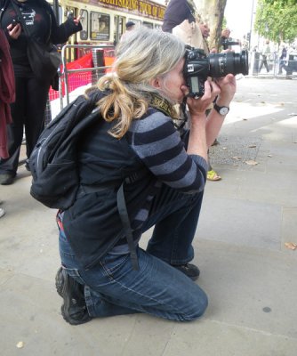Squatting Blonde Photographer