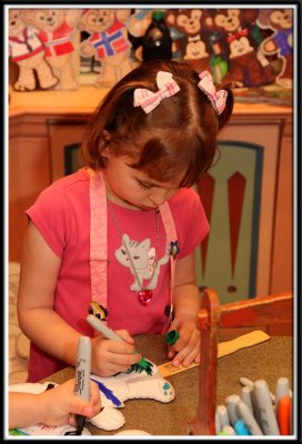 Kylie works on coloring her Duffy Bear on a stick