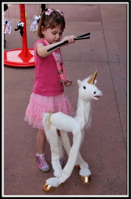 Kylie plays with a unicorn in Japan