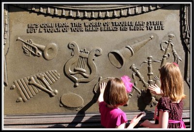 While waiting in line for the Haunted Mansion, the girls touch different instruments on the stone crypt, and they make music!