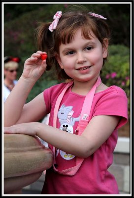 Kylie throws a candy heart into the wishing well!