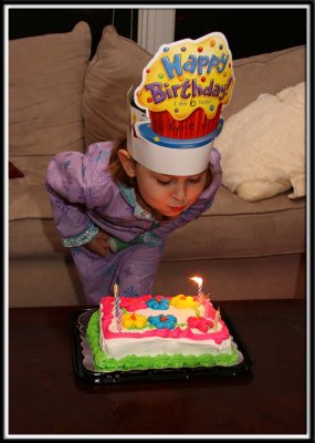 Kylie blows out her candle (by the way, she acquired the hat from school. She was so proud, she wore it all day and night)