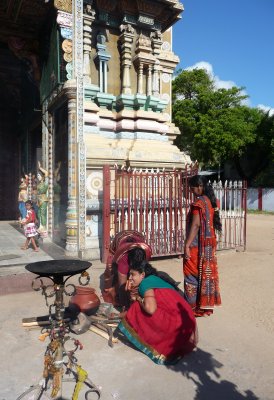 Women tending sacred fire at Hindu temple