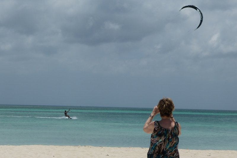 Linda watches a kite surfer at the beach