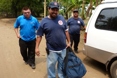 Gerry's crew get the bags of kid's packs from the truck